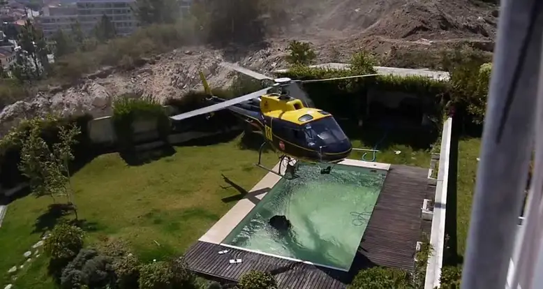 Helicopter Pilot Takes Water From A Swimming Pool