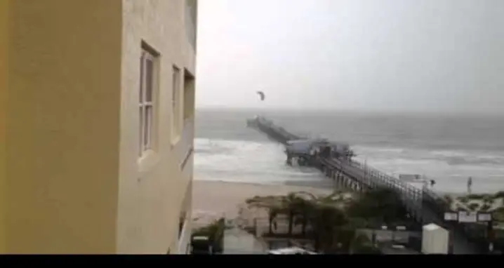 Kite Surfer Flies Over A Pier